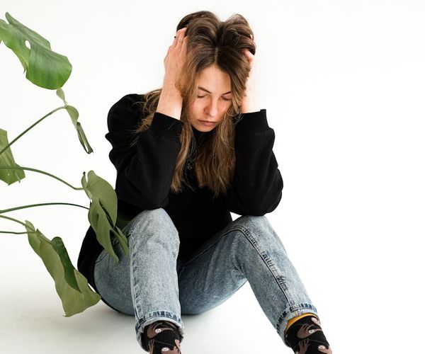 Person sitting in a calm, meditative pose with a serene expression.